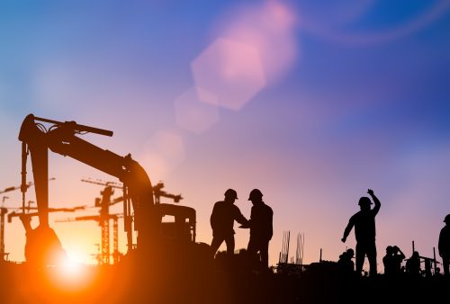 Silhouette of engineer and construction team working at site ove